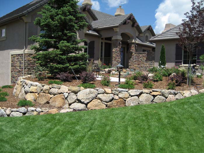 Retaining wall built with large boulders.