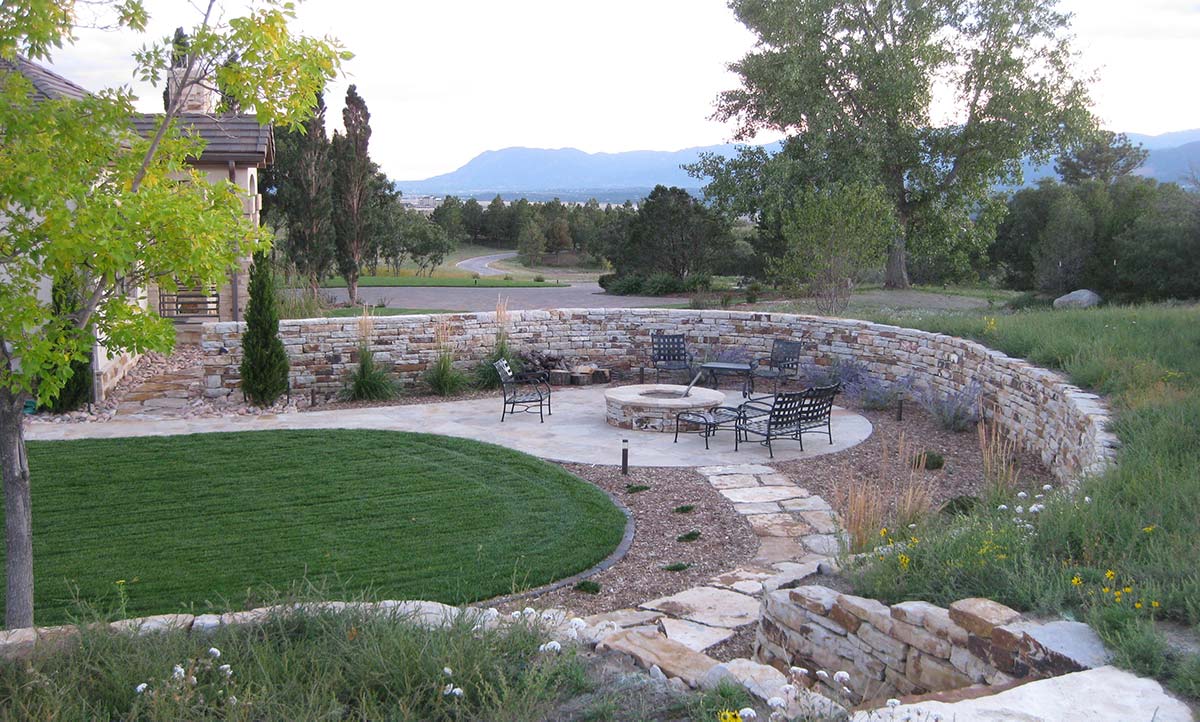 Outdoor living space with fire pit and retaining wall. Outdoor living space with fire pit and retaining wall.