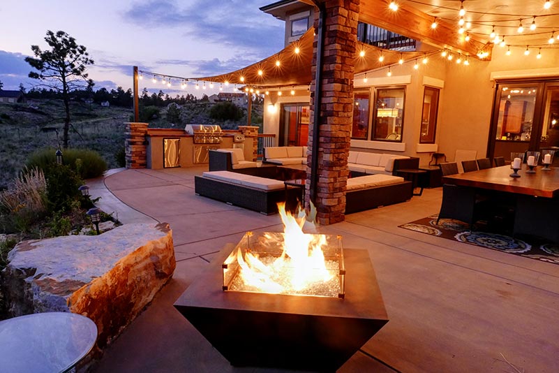 Natural gas fire pit constructed of metal and glass.