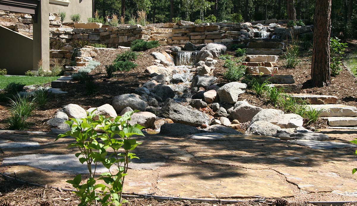 At the base of this water feature is a Siloam stone patio set in road base.