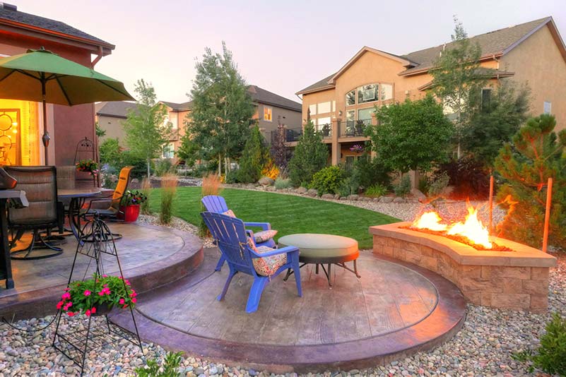 Dense plantings create privacy around this cozy outdoor living space located in Monument.