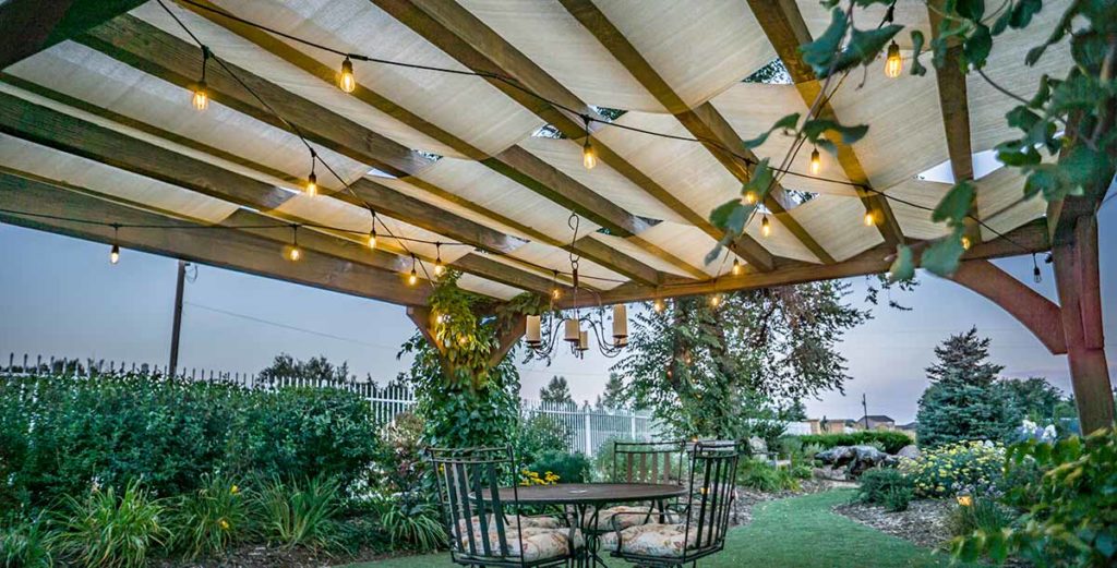 These low voltage LED string lights  hang from the trellis and illuminate this outdoor living area while providing their own distinct ambiance.