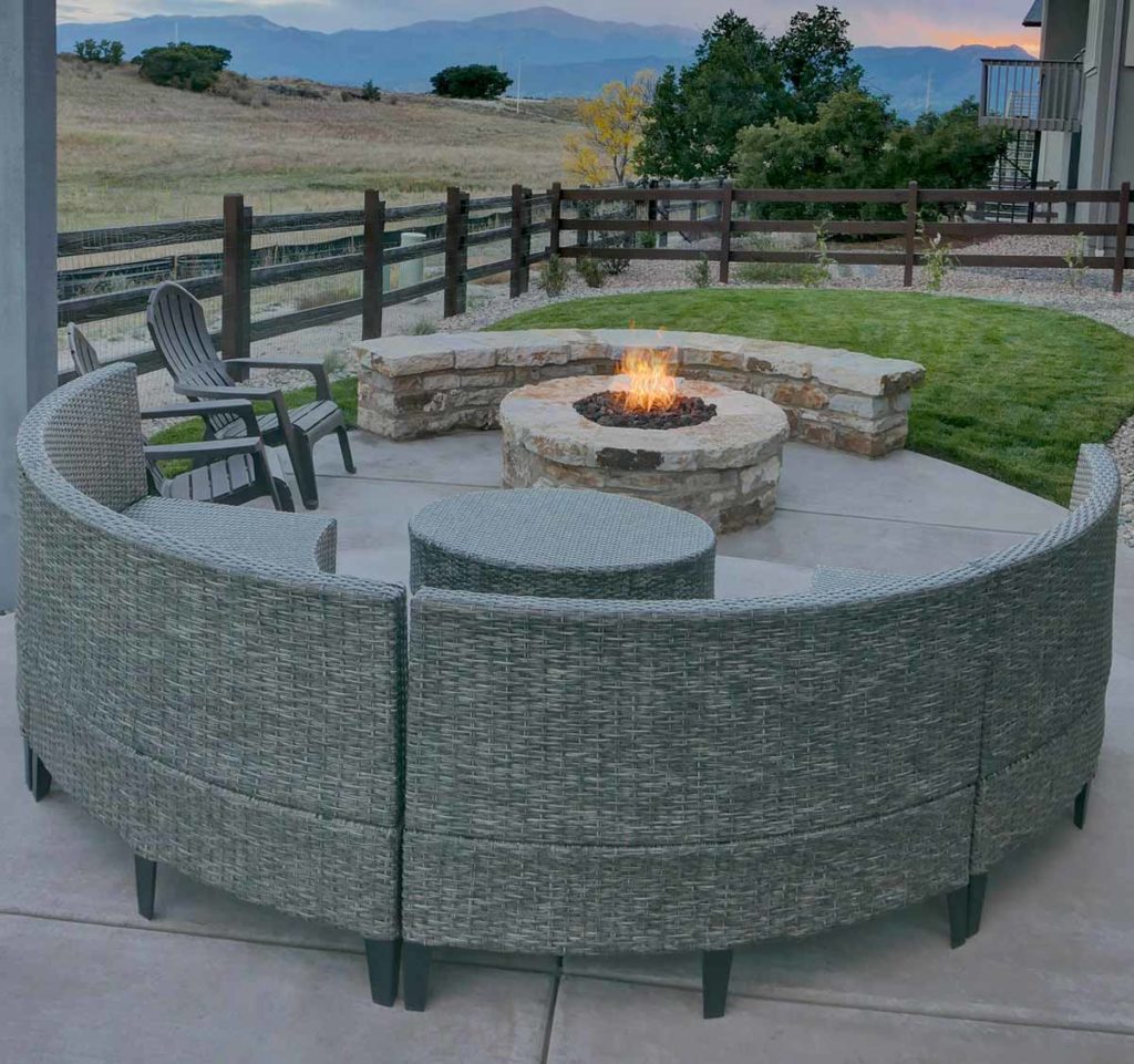 Xeriscaped backyard with fire pit and small area of turf.