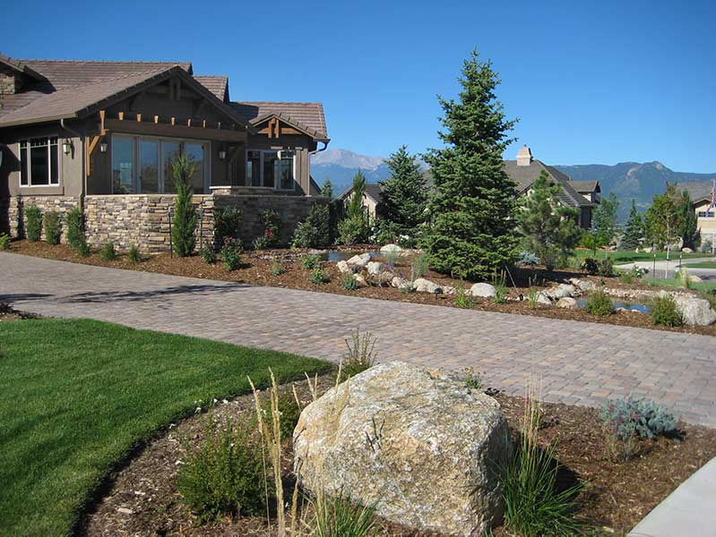 This  Pine Creek residence doesn’t have any shortage of curb appeal; its paver driveway and water feature make it stand out.