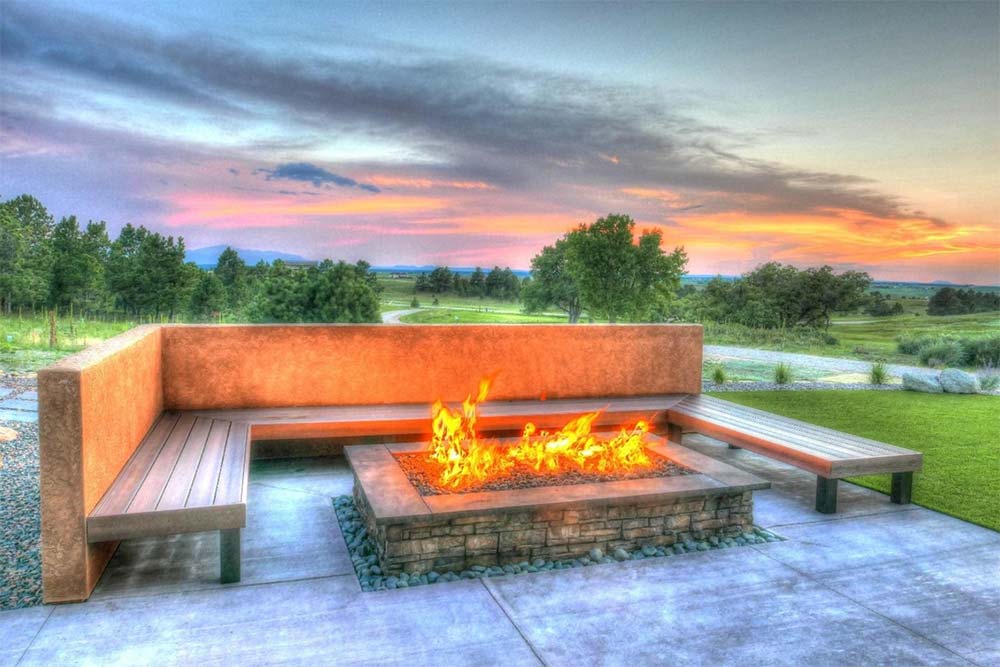 Fire pit with seating in a beautiful residential landscape design.
